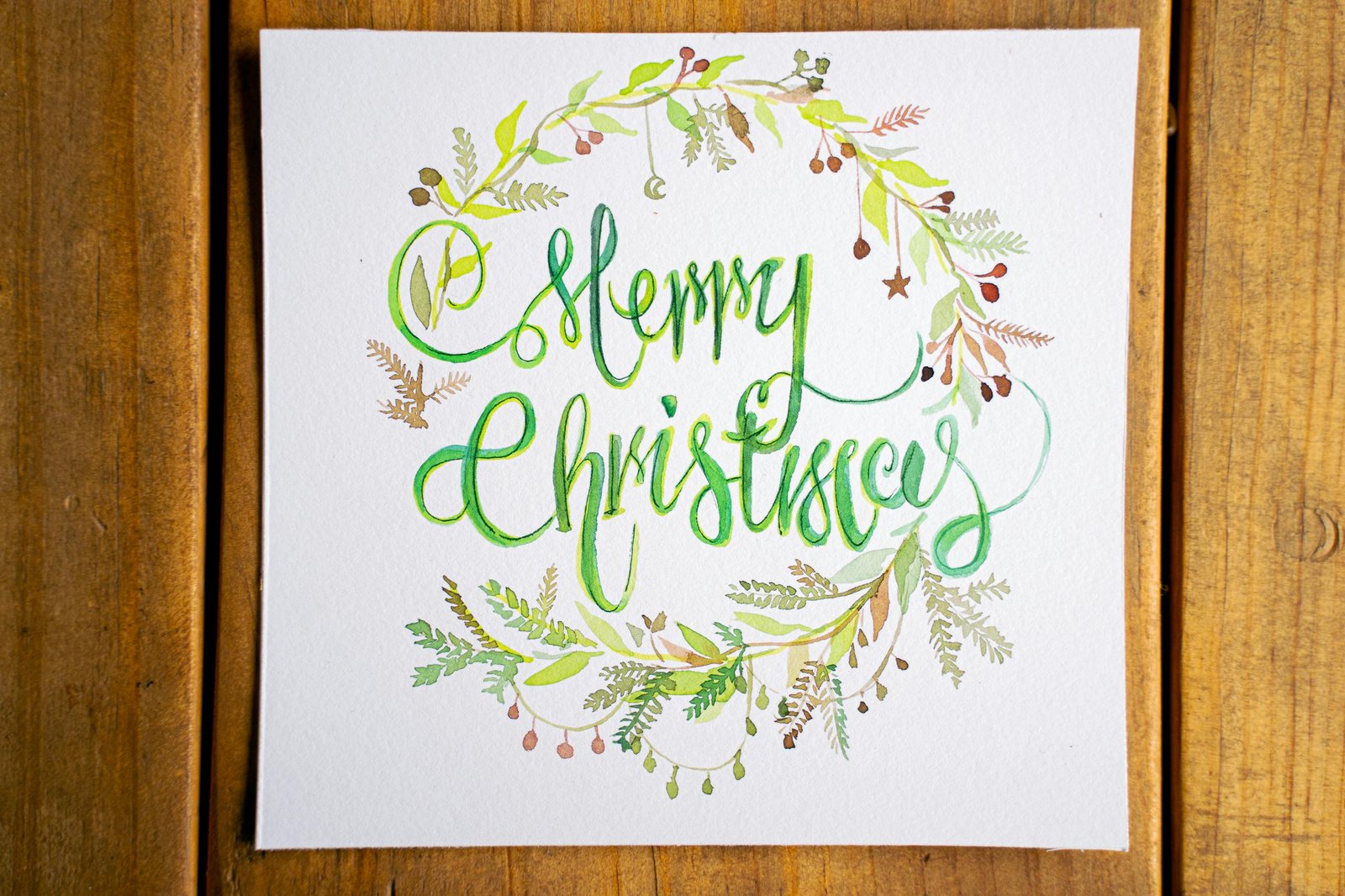 Beautiful handmade Merry Christmas card with artistic calligraphy and festive design.